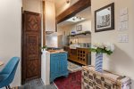 Path into kitchen featuring an antique carved wood door